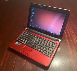 A photograph of a Netbook on a table, running the LXQT desktop environment